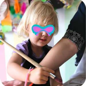 Child painting with adult guidance